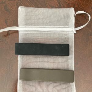 Pony-O Silicone Hair Ties. One black and one brown.